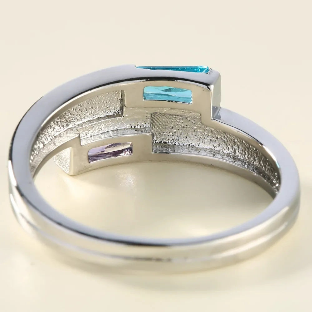 Silver electroplated copper ring with a zircon stone inlaid in the band.