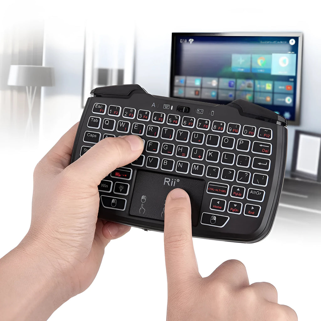 Black wireless mini keyboard with USB receiver on desk