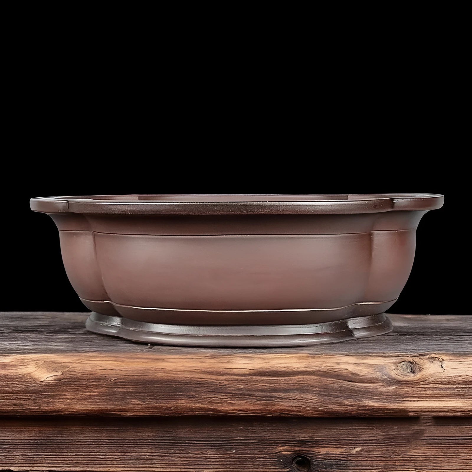 Handmade antique crabapple shaped large purple clay flowerpot on a floor.