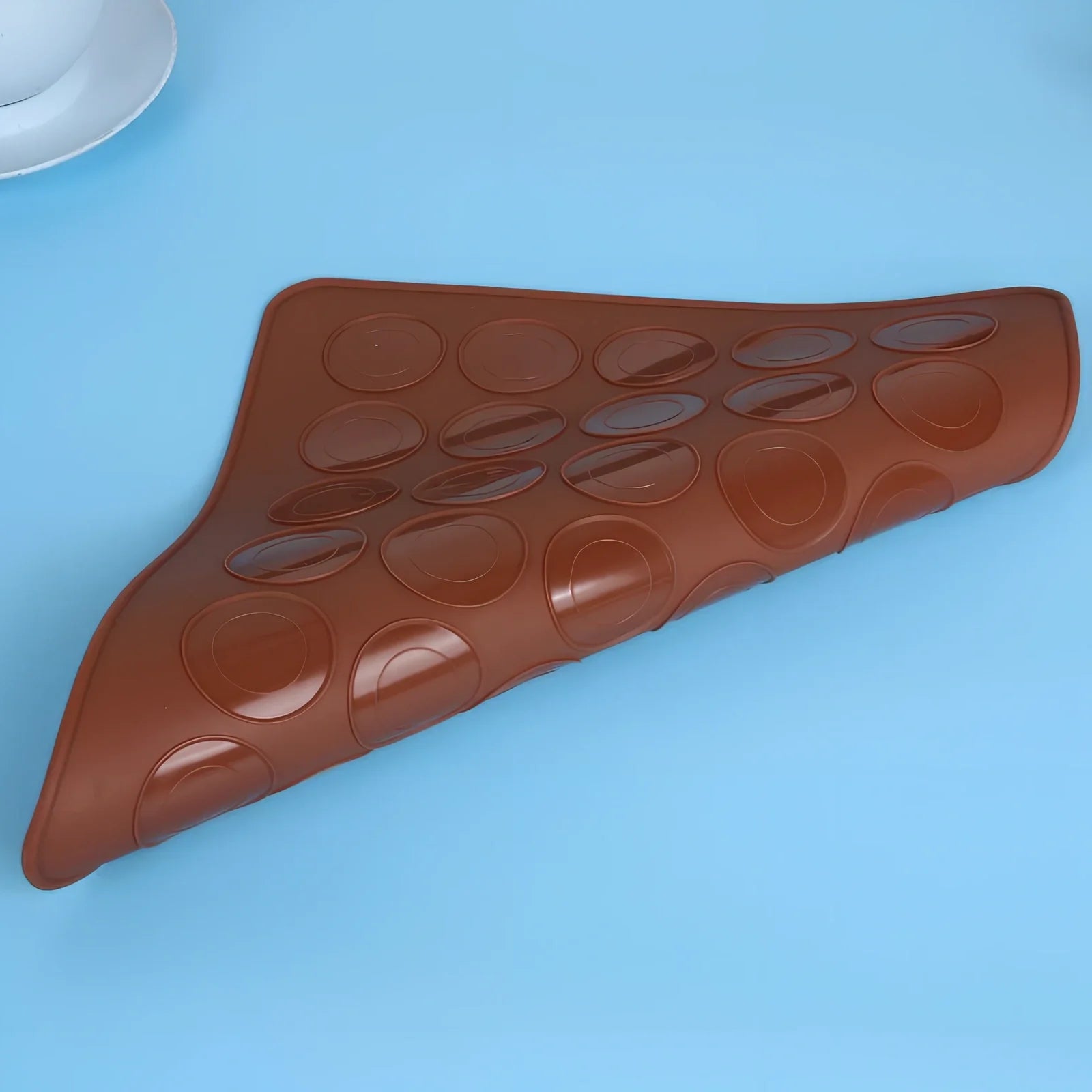 Brown silicone baking mat 29.5 cm x 21.5 cm with 2.3 cm and 3.7 cm circles for non-stick oven baking