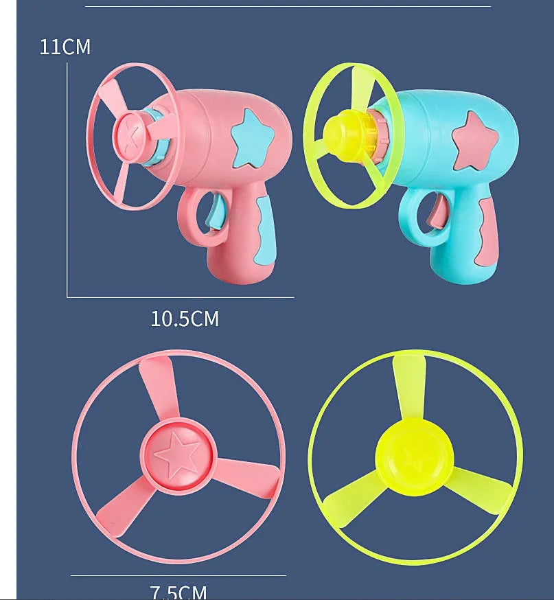 Plastic flying saucer launcher toy set with LED lights and coloured discs on outdoor grass.