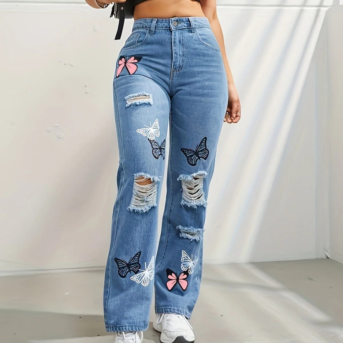 Women's high-waisted straight-leg jeans with butterfly print and distressed details