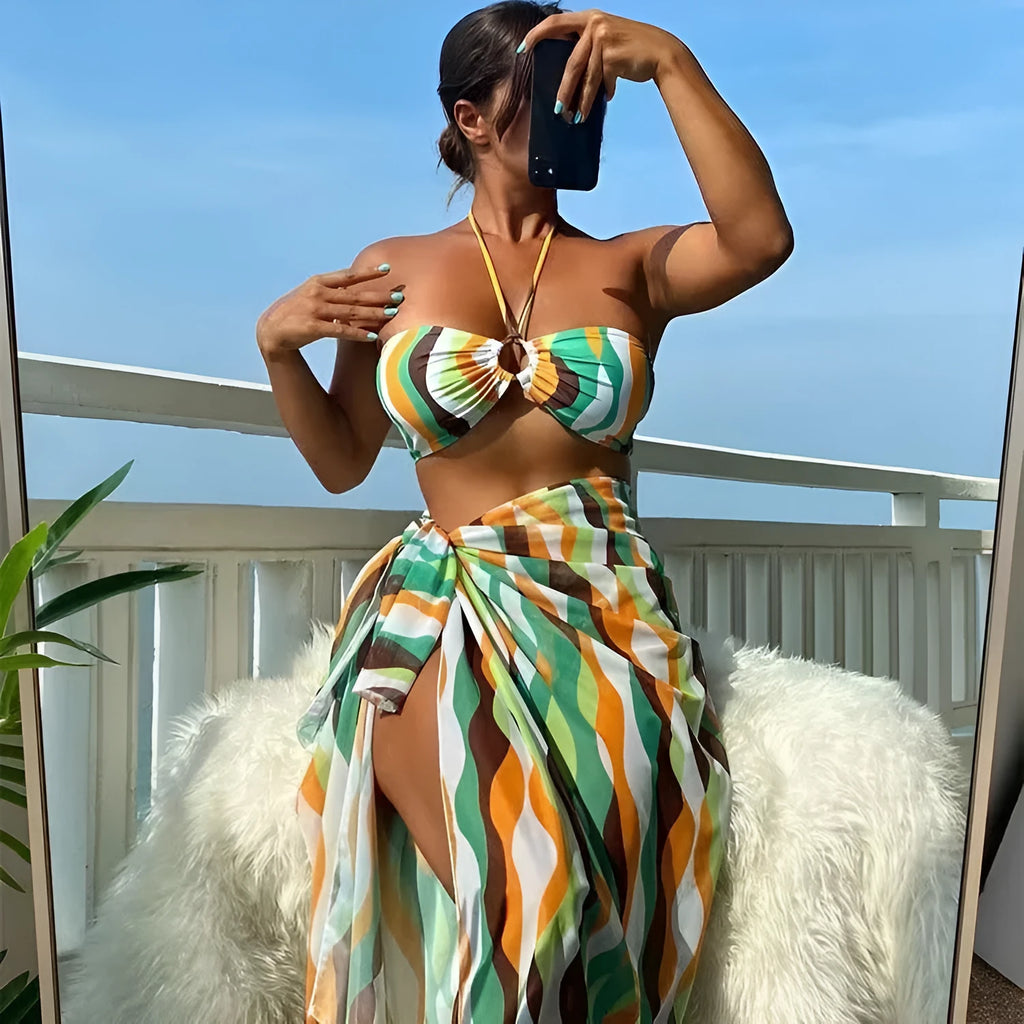 Yellow green women's three-piece bikini set with printed skirt on a hanger.