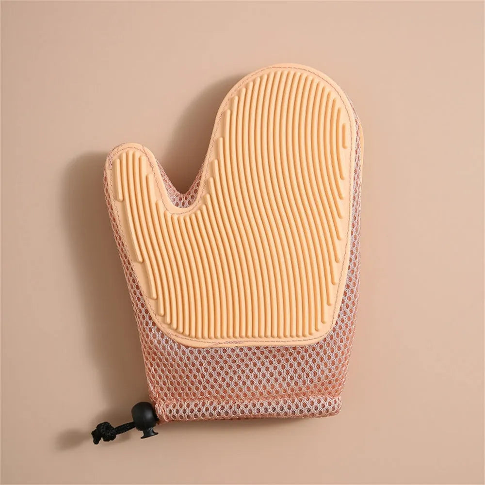 Dark blue mesh pet hair remover glove shown on a hand, with loose pet hair collected on its surface
