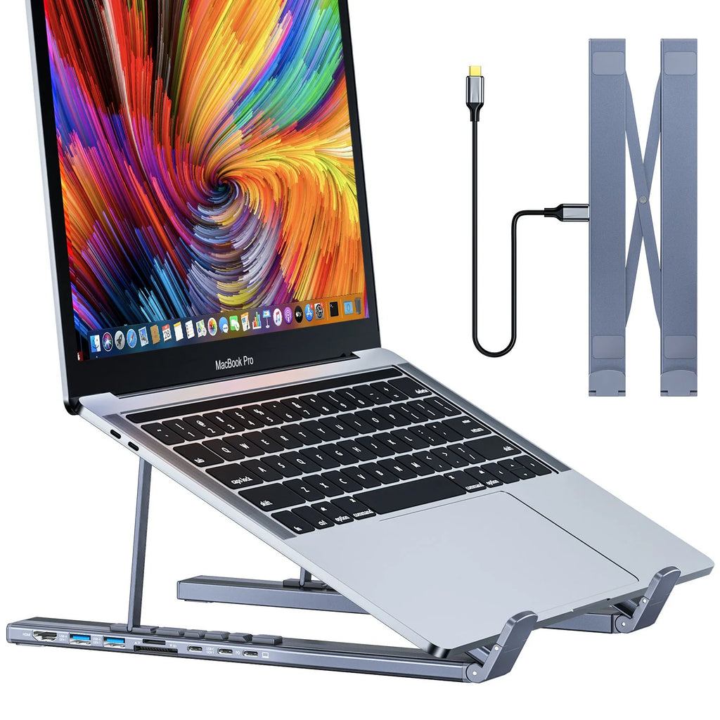 Aluminium alloy folding laptop docking station and stand in silver, shown with multiple USB and HDMI ports.