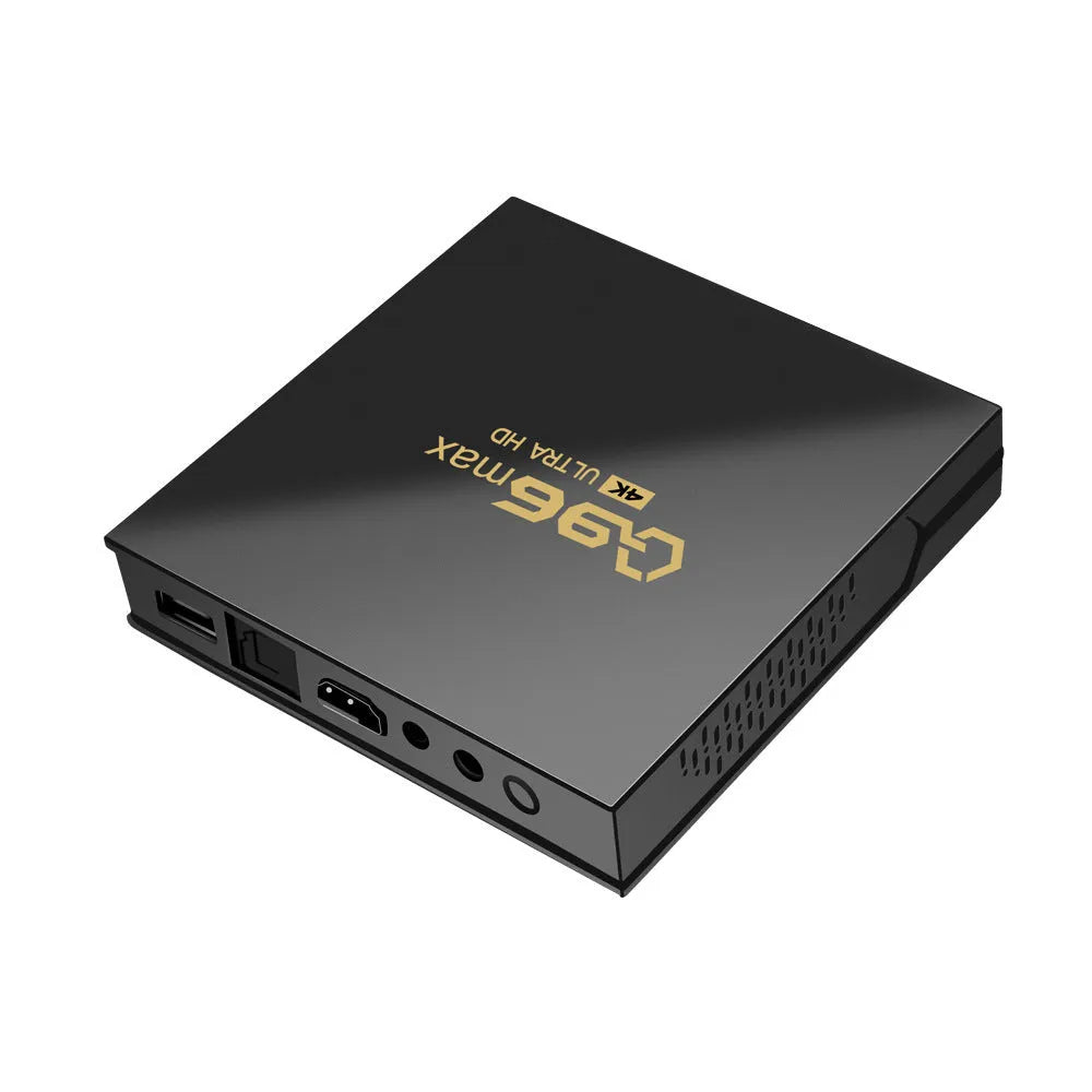 Q96 MAX S905 Android 4K TV Box streaming media player with remote control and accessories on a wooden table.