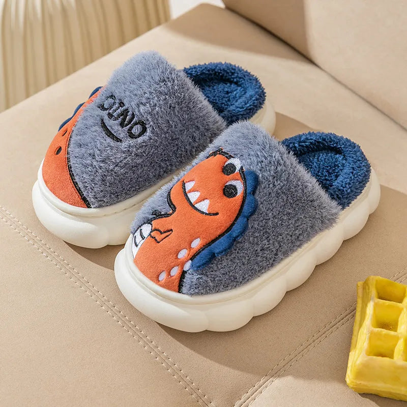A pair of plush, thickened couple slippers in a dinosaur pattern, shown in grey, coffee, or orange yellow.