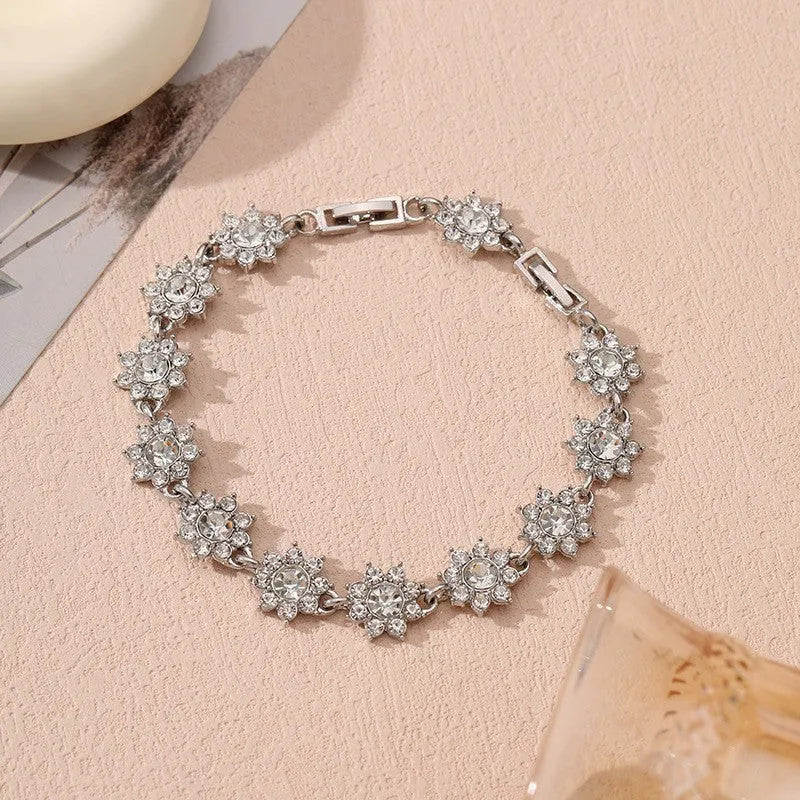 Electroplated zinc alloy bracelet with flower-shaped design and coloured gem elements in metallic finish