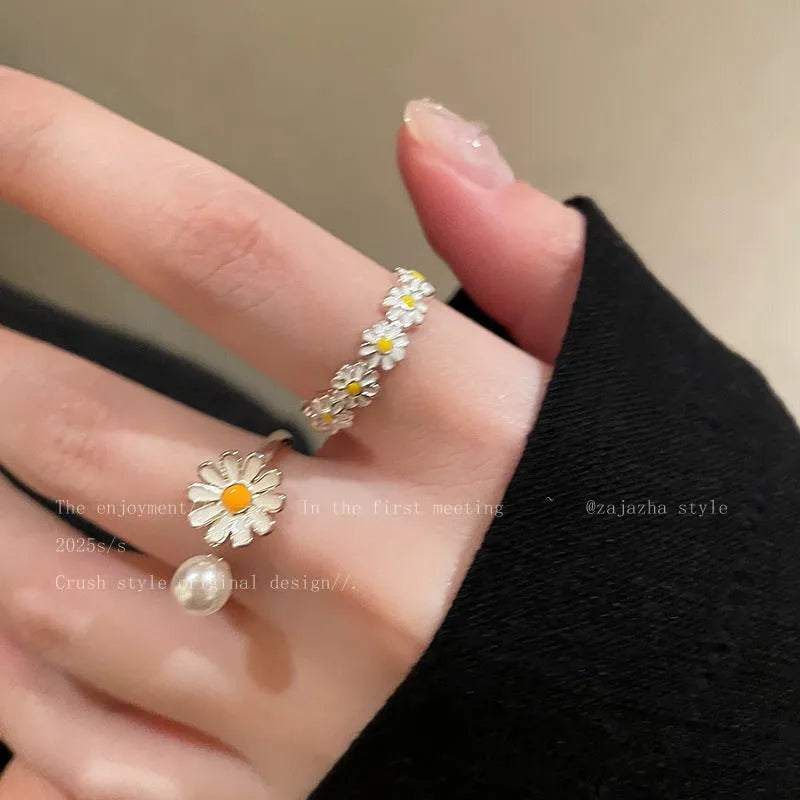 Women's adjustable copper ring set showing little daisy pearl ring and plain daisy ring with opening design.