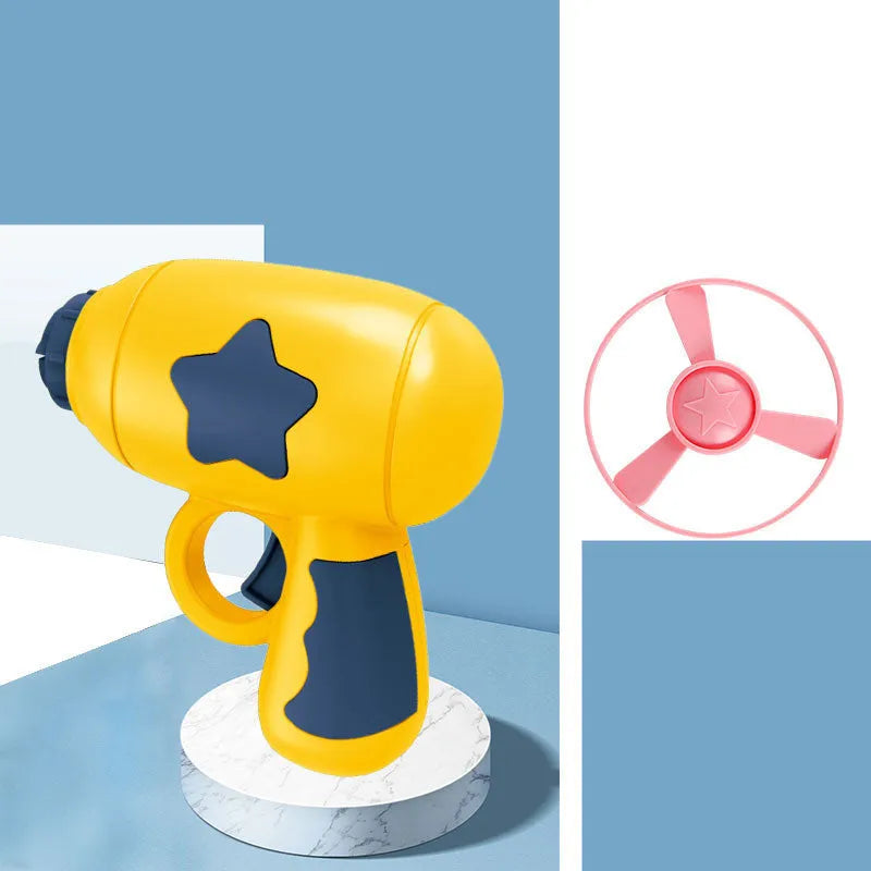 Plastic flying saucer launcher toy set with LED lights and coloured discs on outdoor grass.
