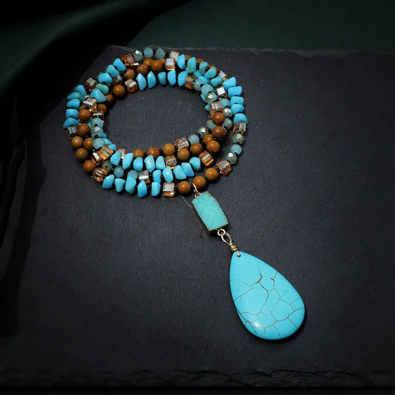 Turquoise water drop shaped pendant necklace with mixed gem inlaid detailing on ball bead chain