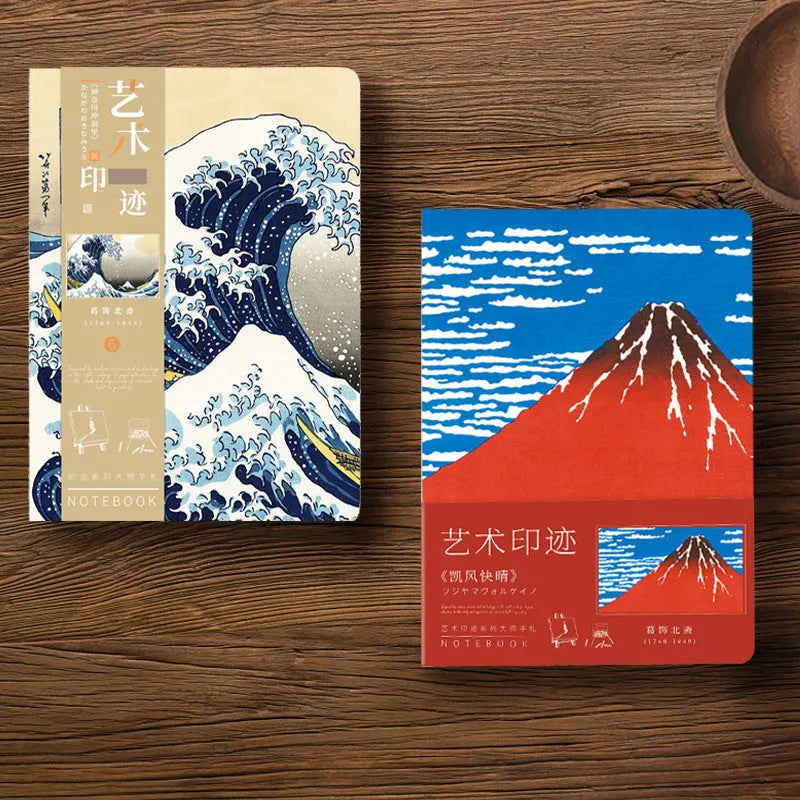 Ukiyo-e art hand ledger notebook open on a desk showing detailed Kanagawa wave cover and lined pages.