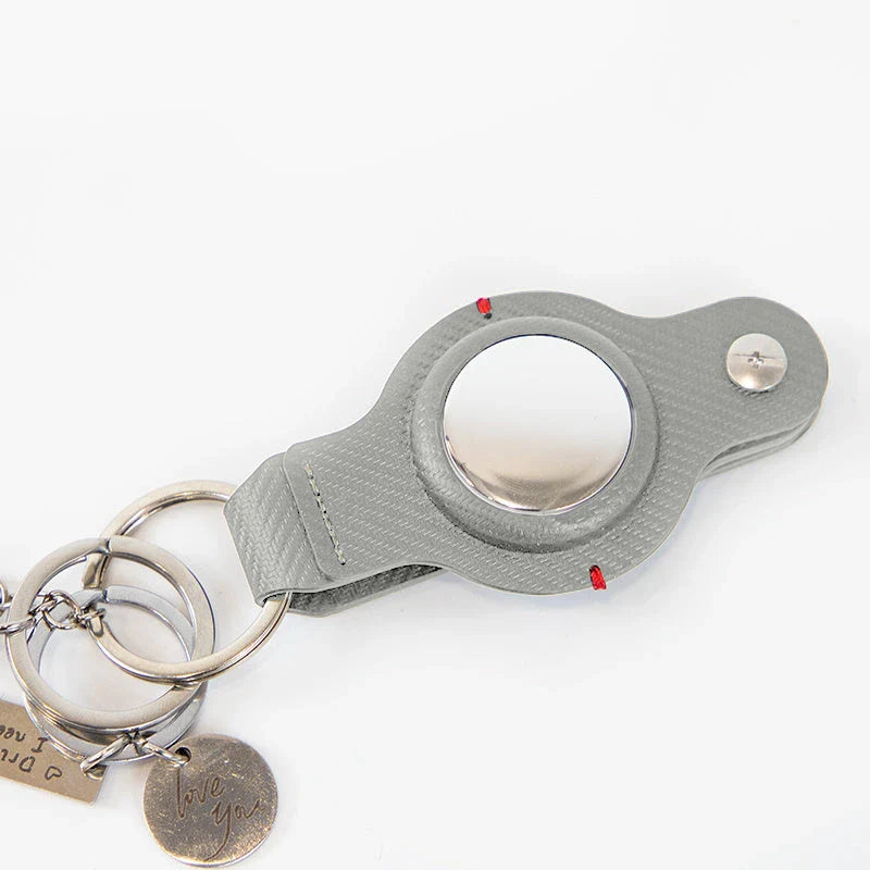 Stylish and durable PU leather AirTag key holder with keychain, available in black and grey colors