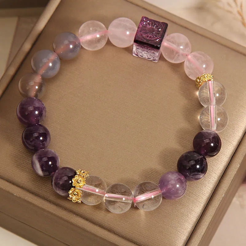 Close-up of a purple women's bracelet with 10mm amethyst crystal beads and rhinestone decoration on an adjustable strap.