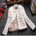 Women's short white faux fur top with regular sleeves, shown on a hanger.