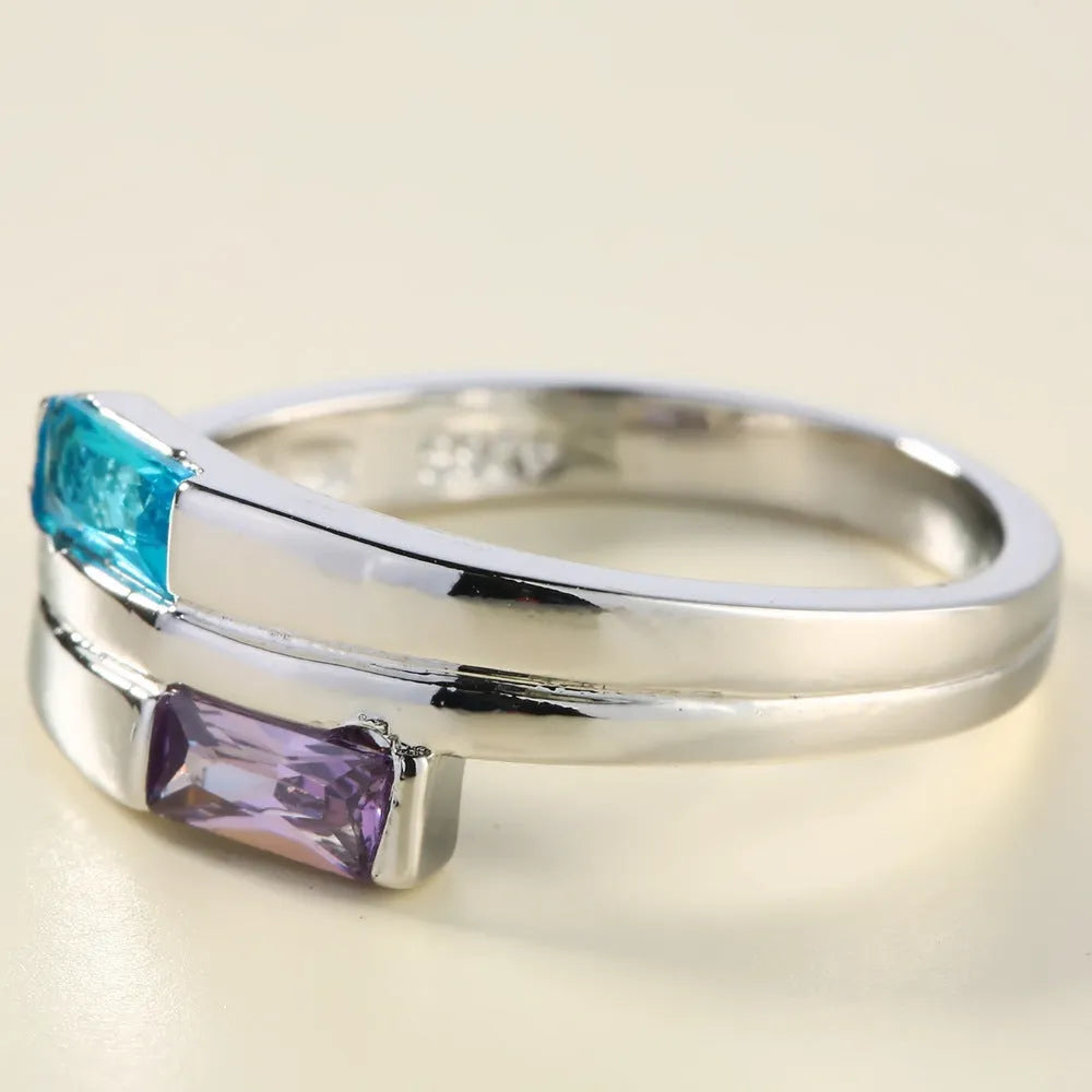Silver electroplated copper ring with a zircon stone inlaid in the band.