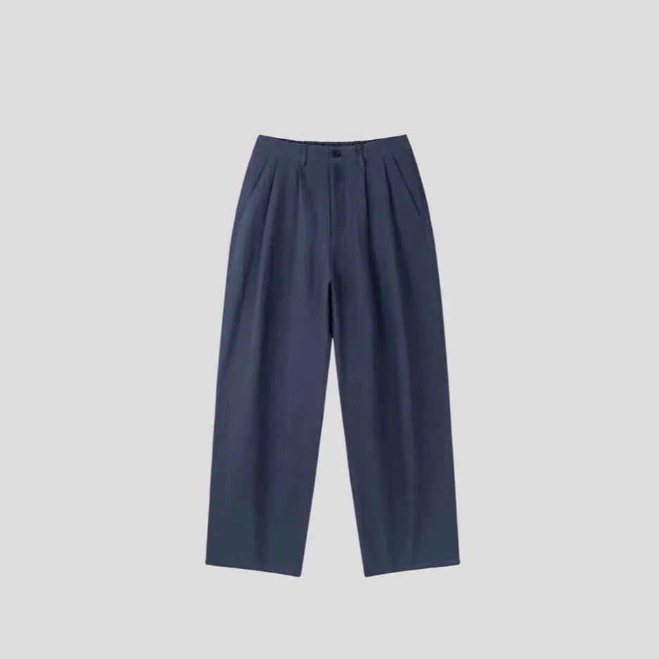 Men's apricot coloured wide-leg cotton linen suit trousers with a loose fit and pencil pants leg opening.