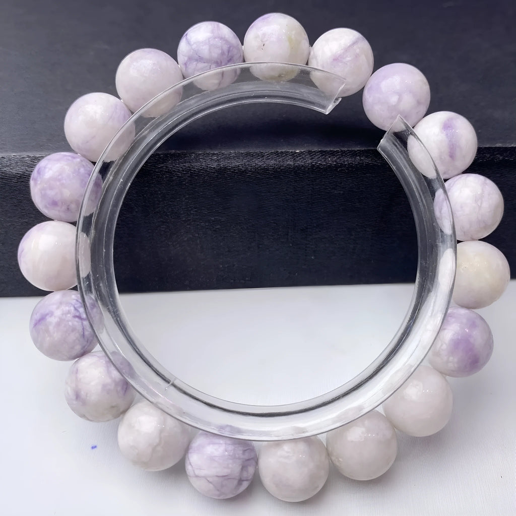 Women's purple turquoise bracelet with natural gemstone beads on a wrist.