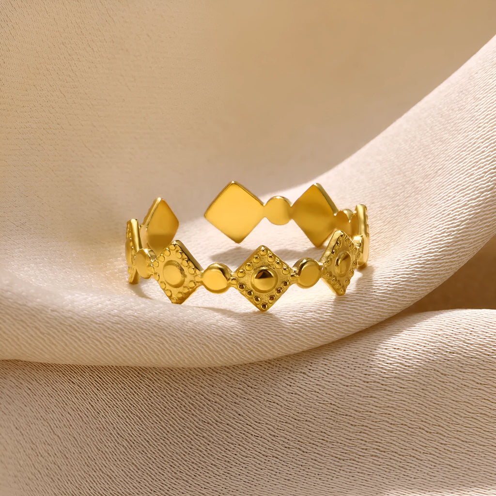 Geometric titanium steel women's ring with golden diamond finish showing adjustable free-size design