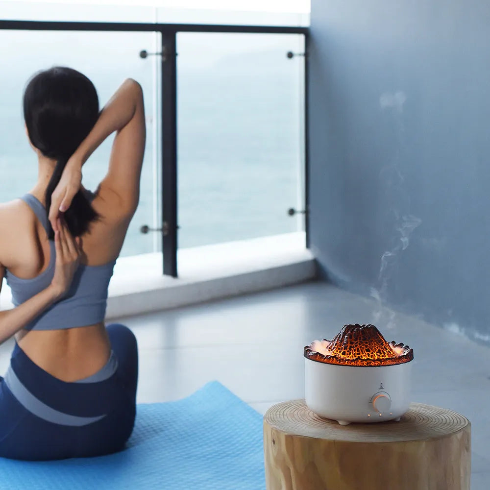 Small white volcano-shaped humidifier with simulated flame lighting and remote control