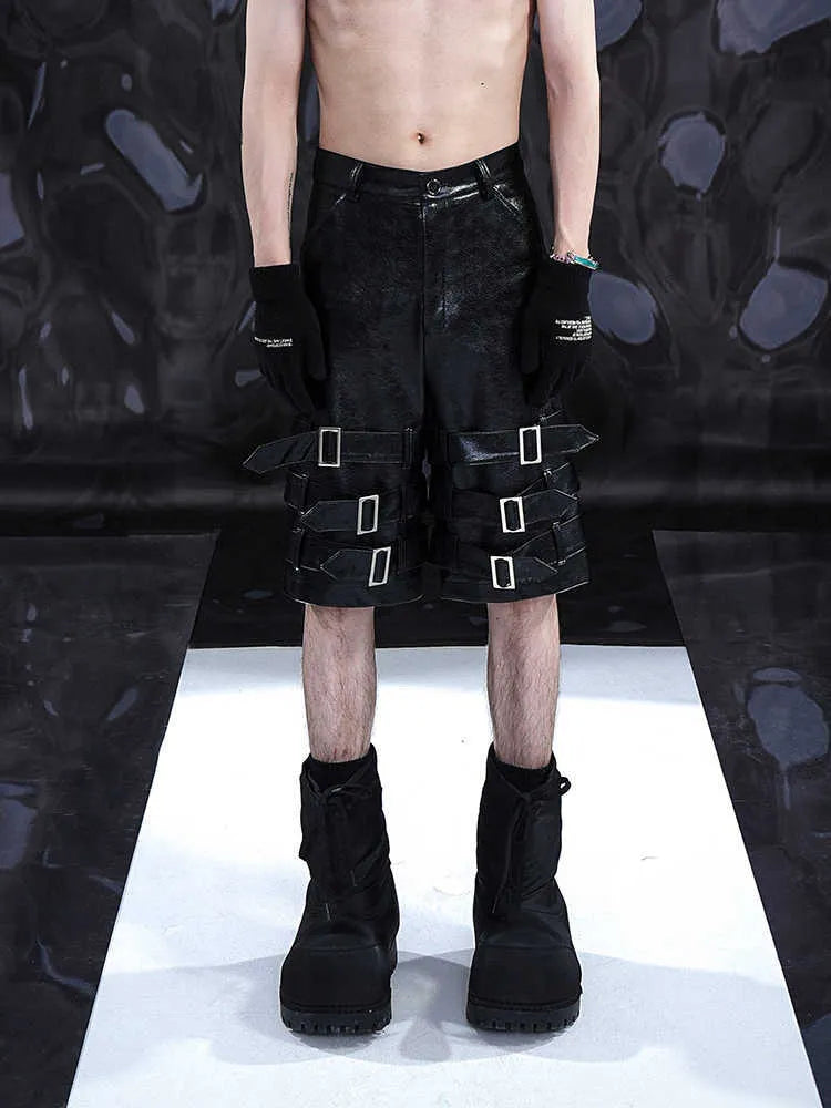 Men's black PU leather casual cropped pants with leather ring details showing medium to low waist construction