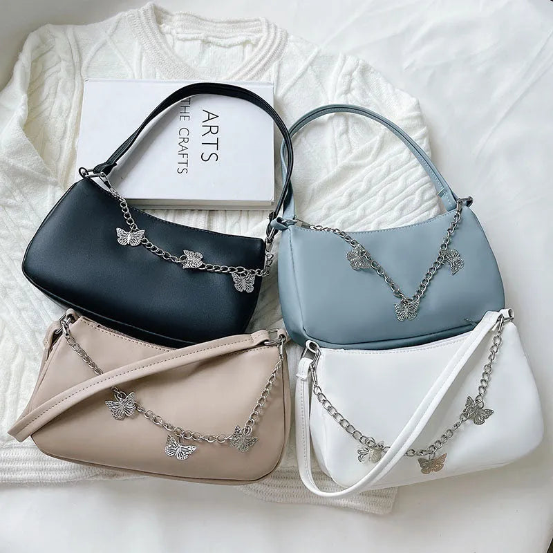 Women's black PU leather crossbody bag with butterfly chain strap and mobile phone pocket
