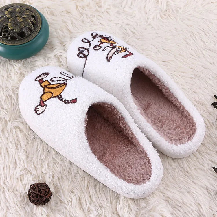 White cartoon pattern fluffy slippers with a plush upper and a non-slip rubber sole.