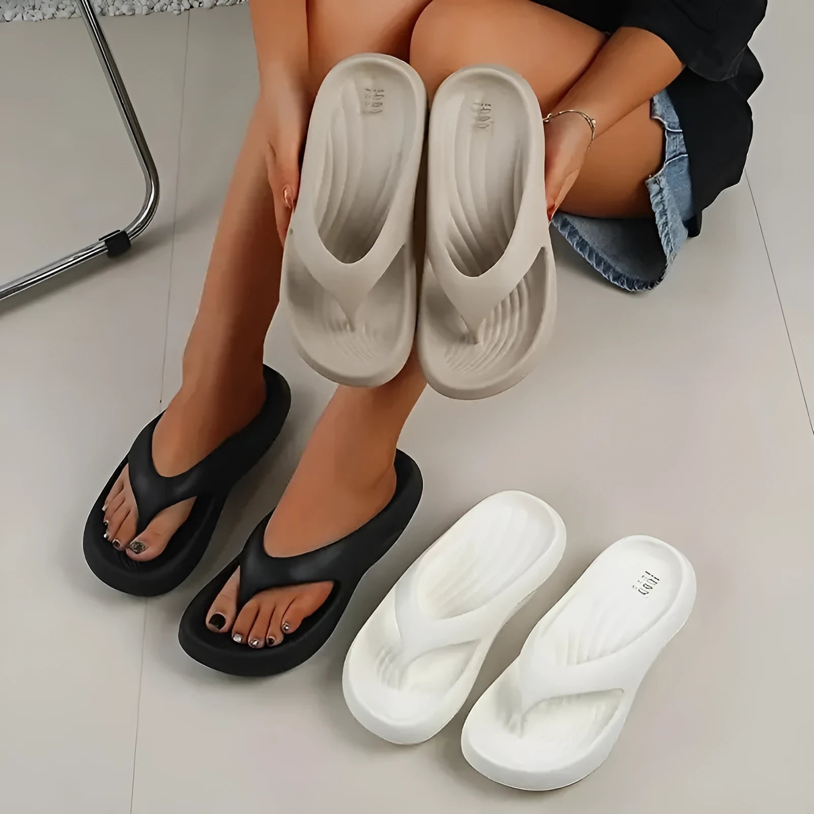 Women's black thick-soled EVA flip-flops with a non-slip patterned sole.