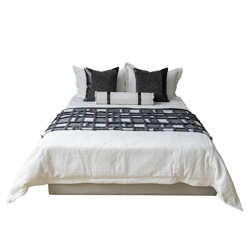 Modern grey and white plaid polyester bed runner set with leather pillow on a 1.8m bed