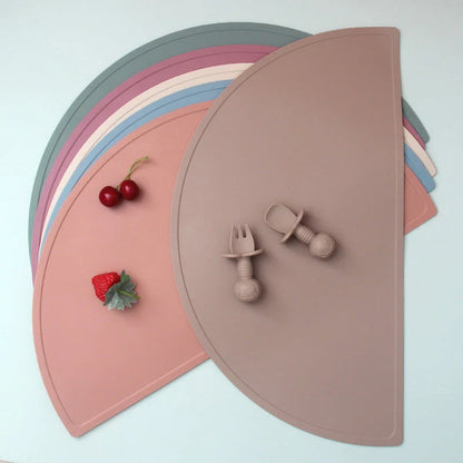 A durable, food-grade silicone placemat in various colours, suitable for Kiwi kids' mealtimes.