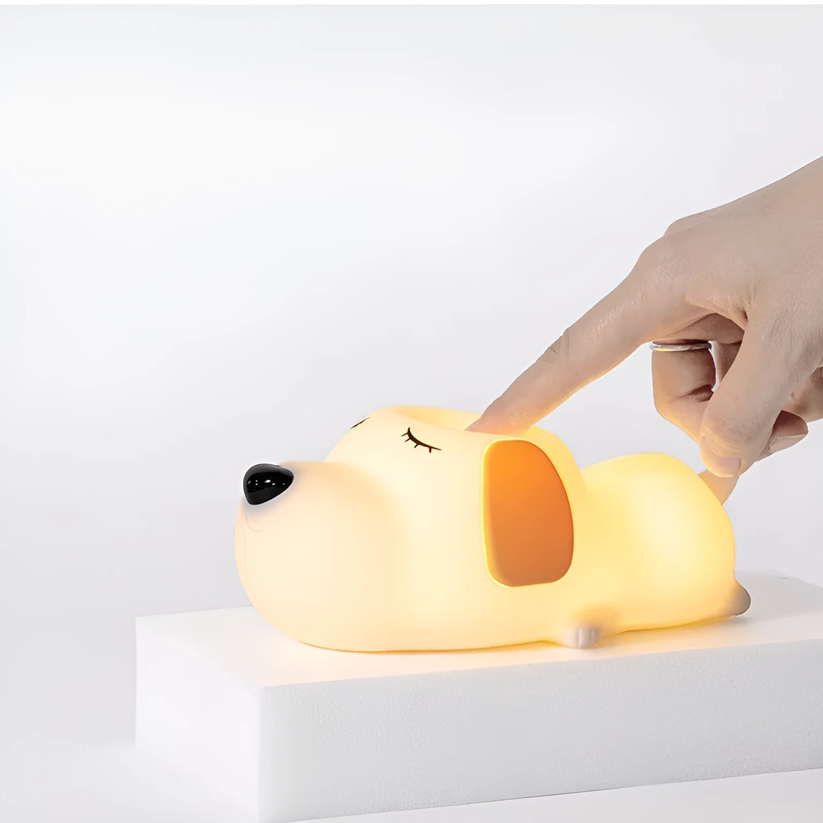 Silicone cartoon dog night light with two-colour design, powered by a USB cable.