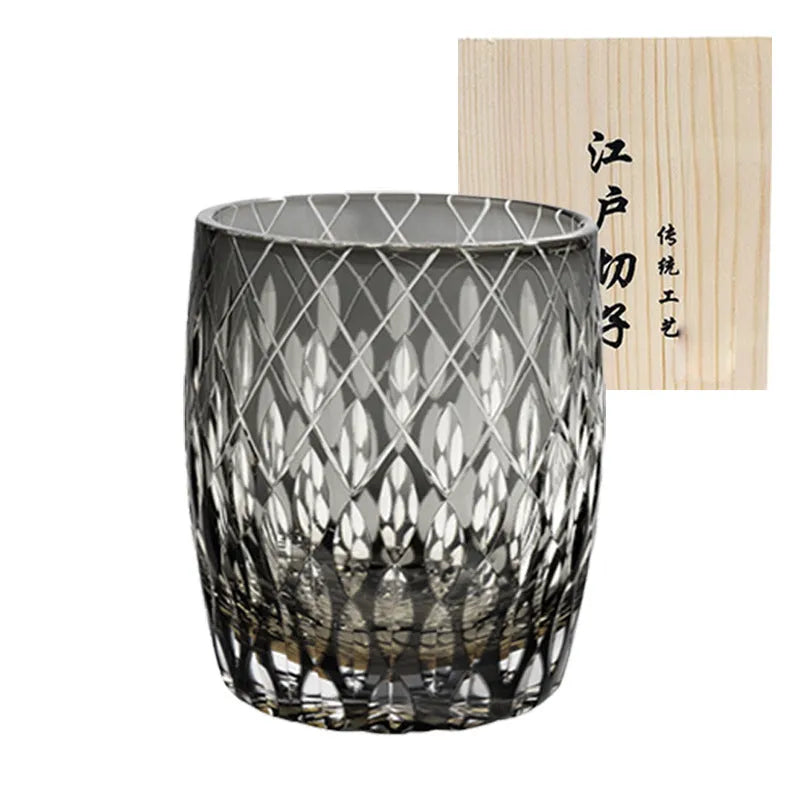 Four Japanese-style Edo crystal glass whisky tumblers in amber and clear cut-glass designs placed in wooden box