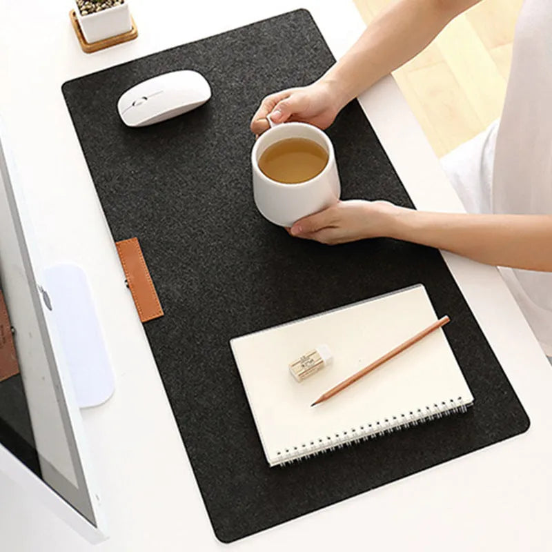 Large felt mouse pad in black on office desk with keyboard and mouse, 325x635mm