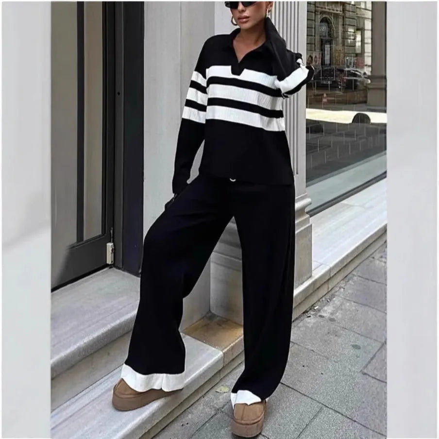 Women's black and white striped knitted polo shirt with matching trousers, a casual two-piece set.
