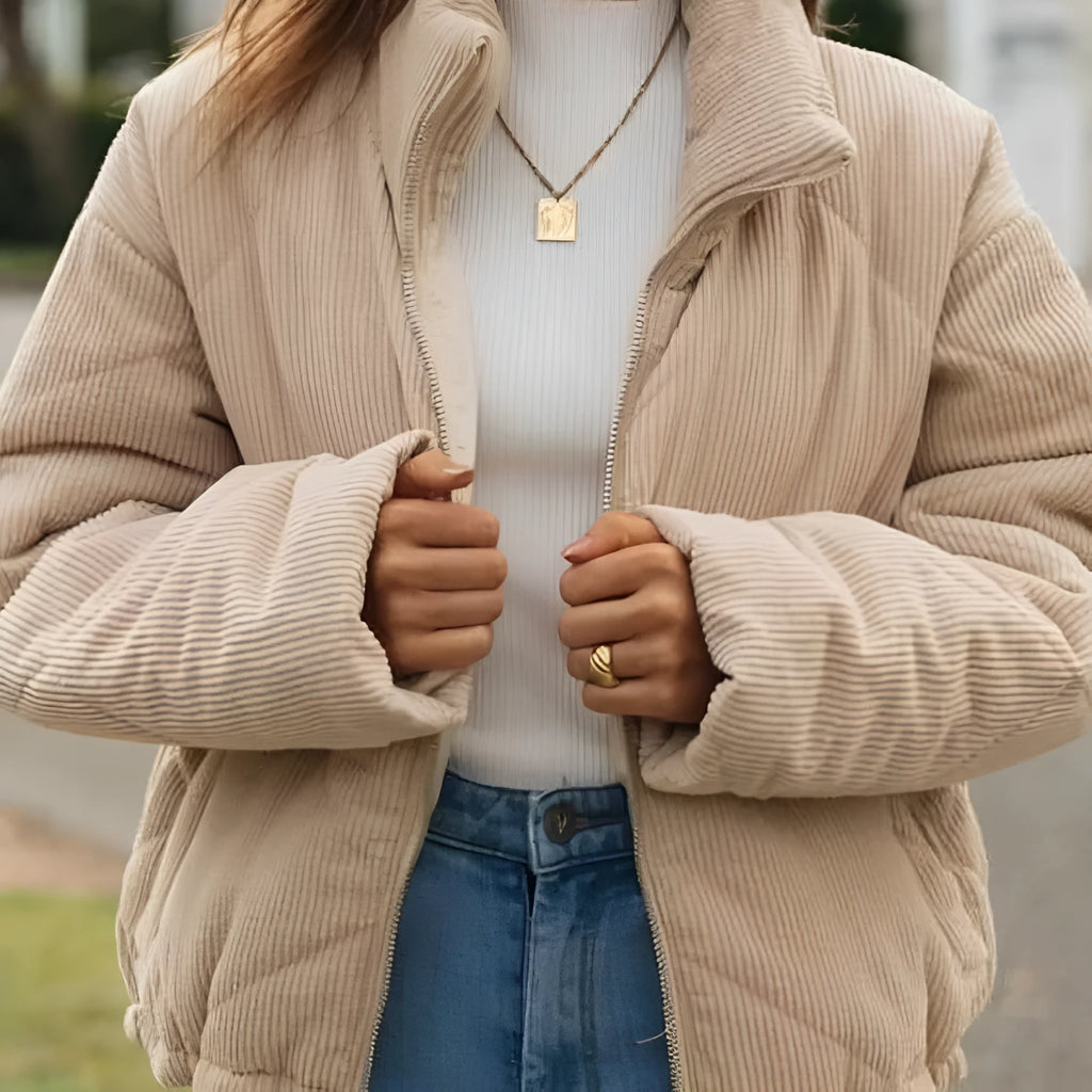 Apricot coloured women's corduroy jacket with a stand collar, front zipper, and long sleeves.