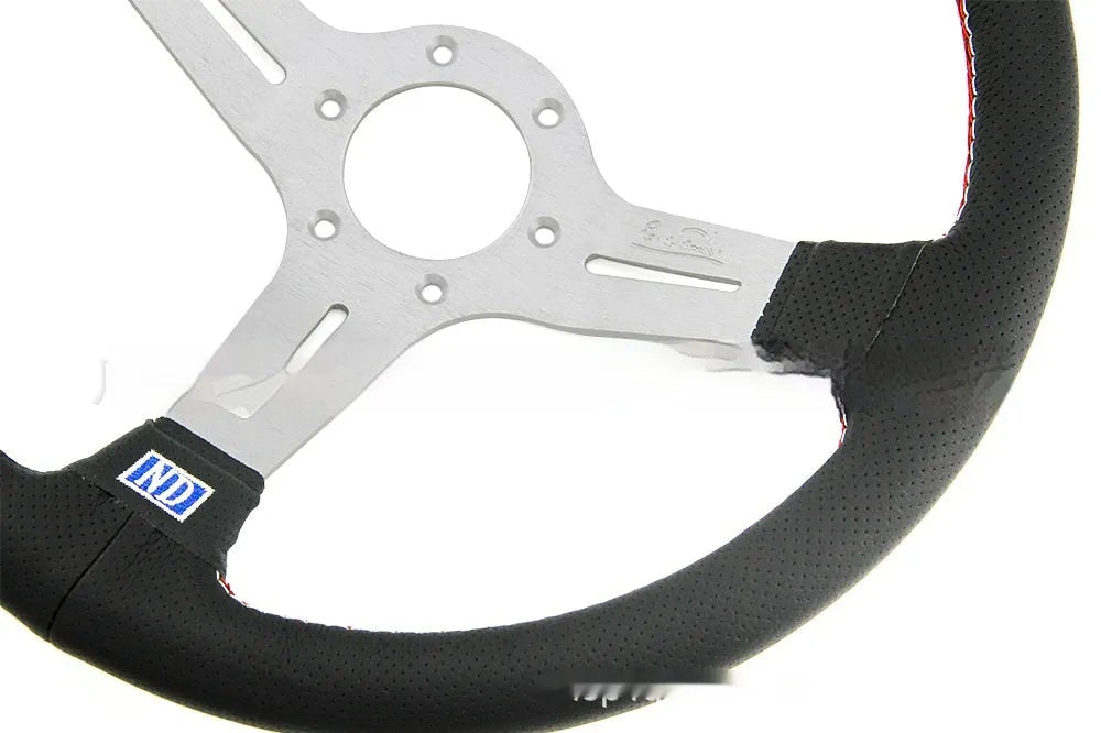 14-inch leather steering wheel with a concave centre and perforated grip, showing black skeleton option.