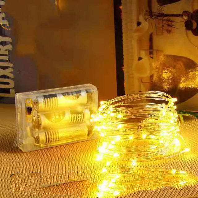 12-metre long copper wire LED string lights with battery box, showing multiple colour options.