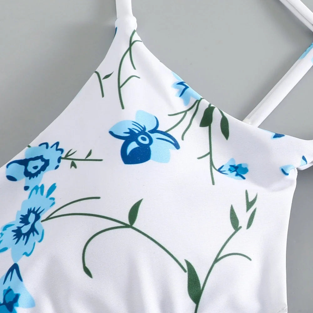 Women's floral pattern tie-neck triangle swimsuit with matching shorts on mannequin