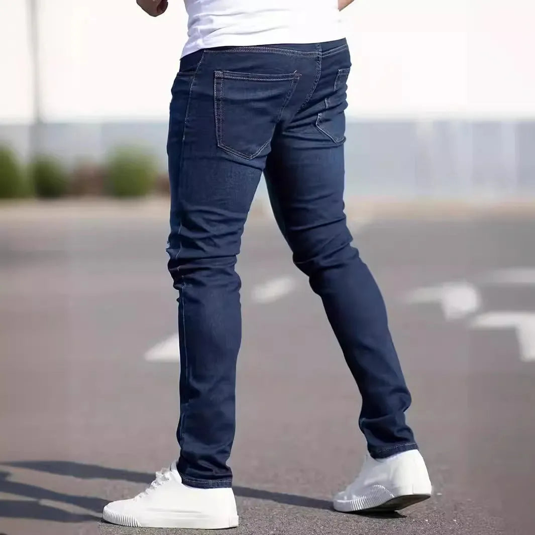 Men's dark blue slim-fit elastic cotton jeans with a skinny leg opening.