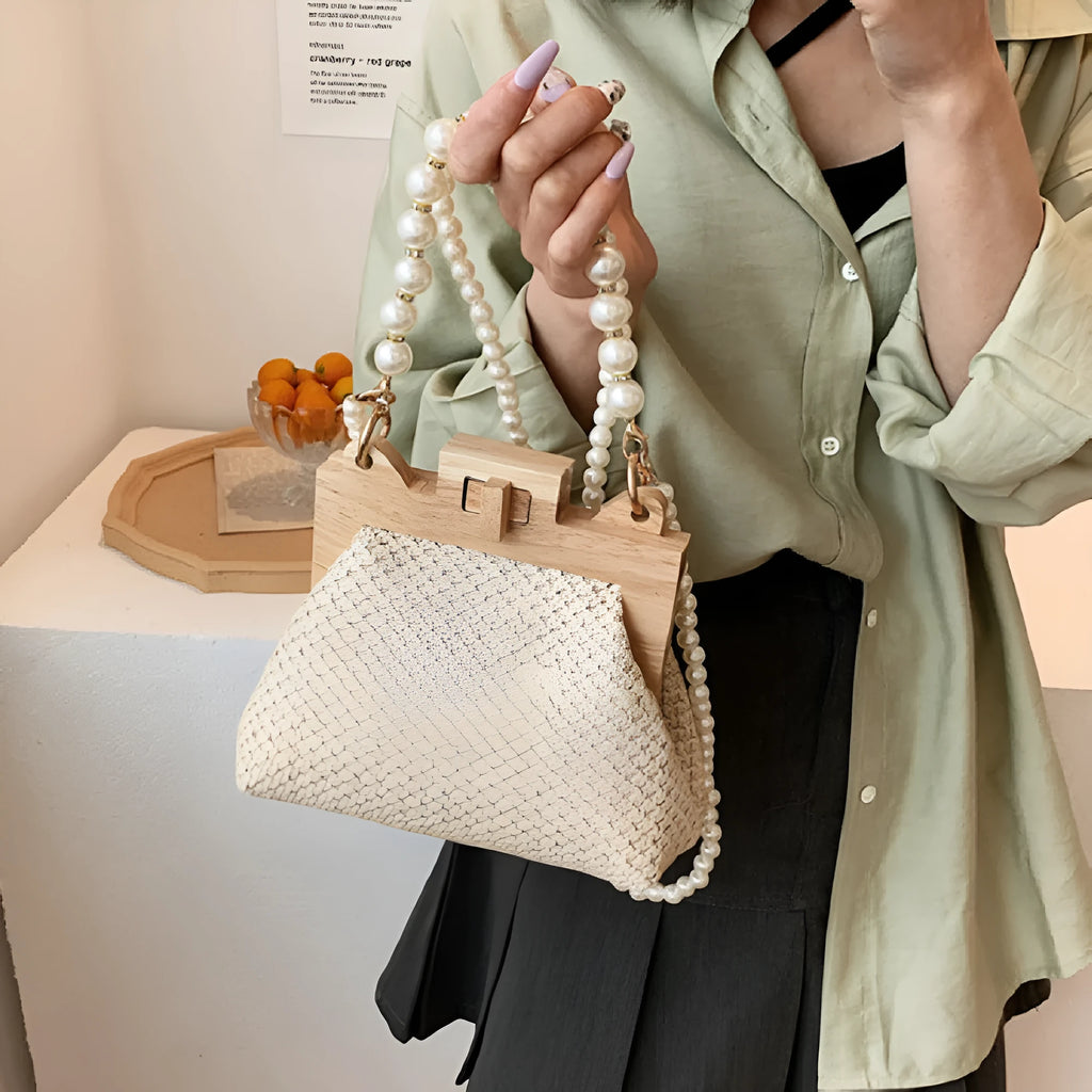 Women's woven straw shoulder bag with pearl chain detail, shown in beige, featuring internal organiser pockets.