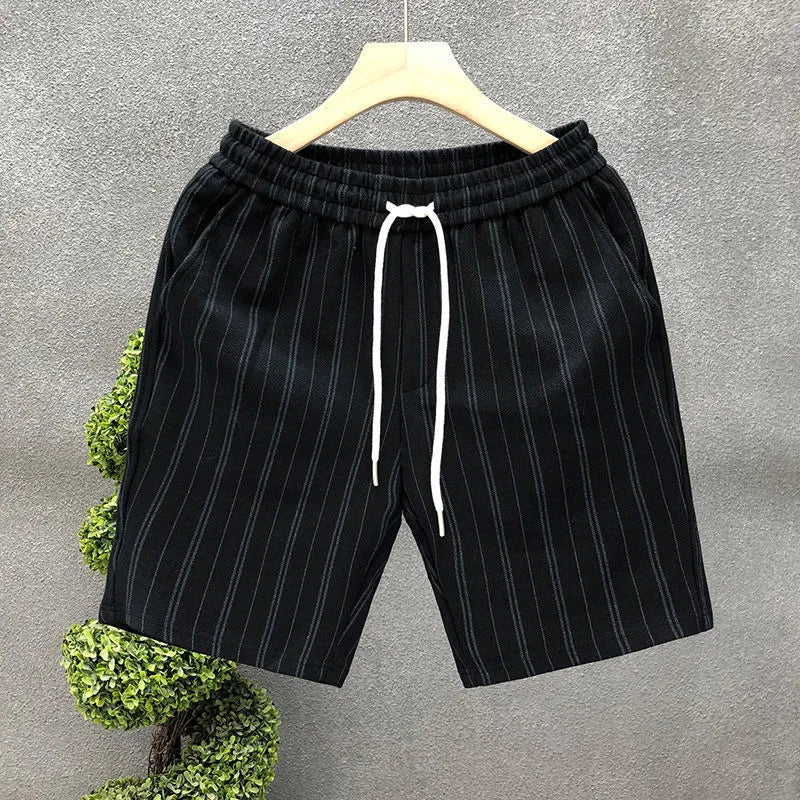 Men's black and white striped casual shorts with fleece lining and elastic waistband