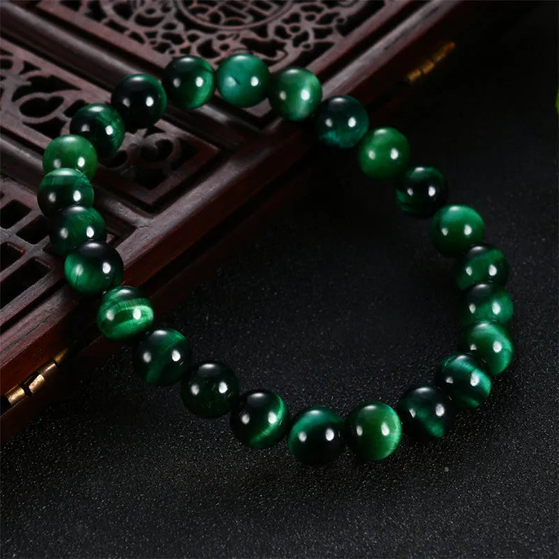 Green tiger eye stone geometric bead bracelet shown in different size options on a wrist.
