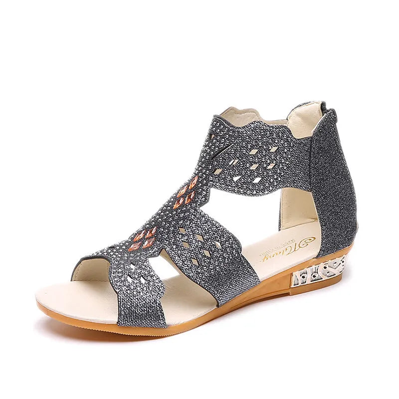 Women's flat open-toe sandals with rhinestone detail and a back zipper in beige.