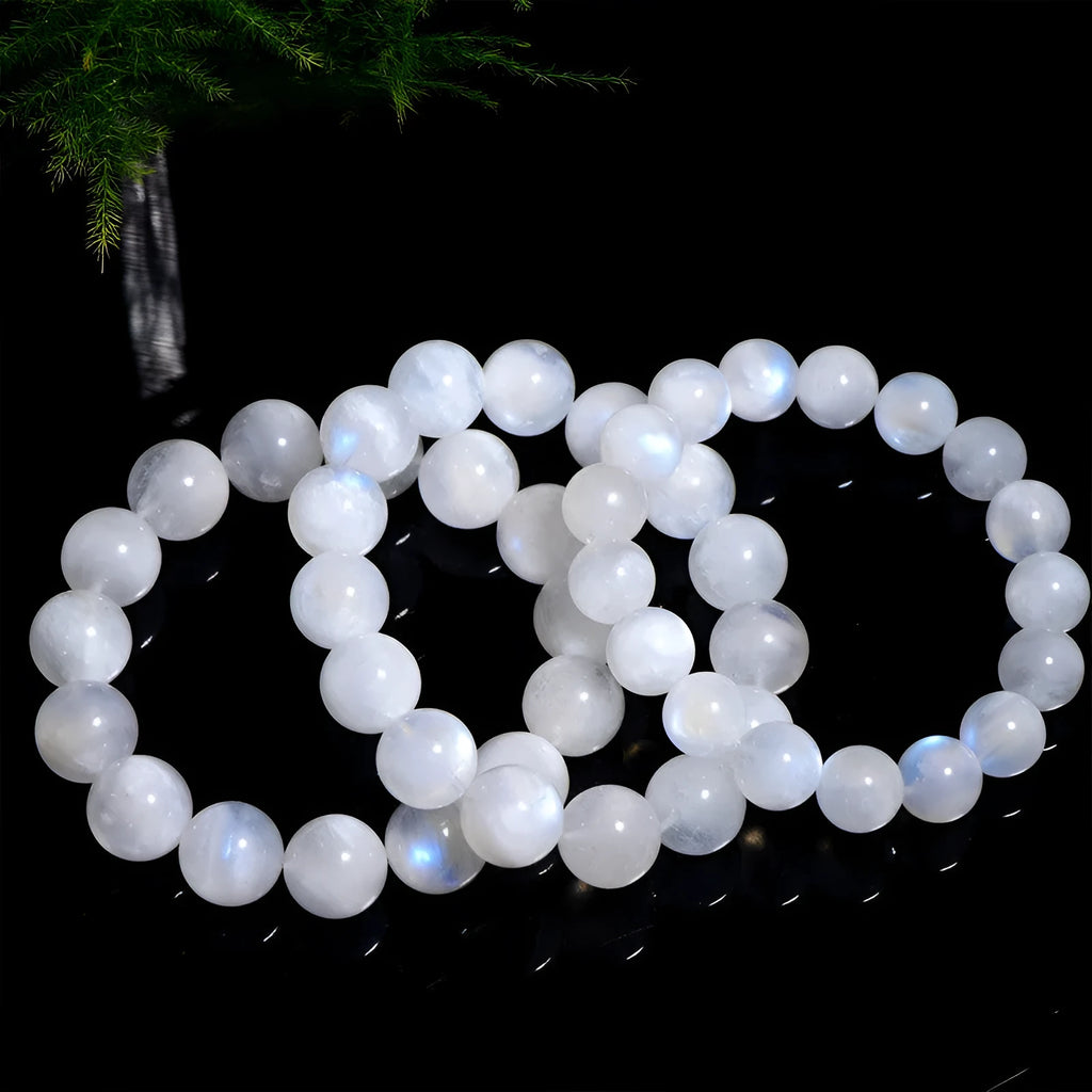 Natural blue moonlight round bead moonstone bracelet in white, showing polished stone surface.