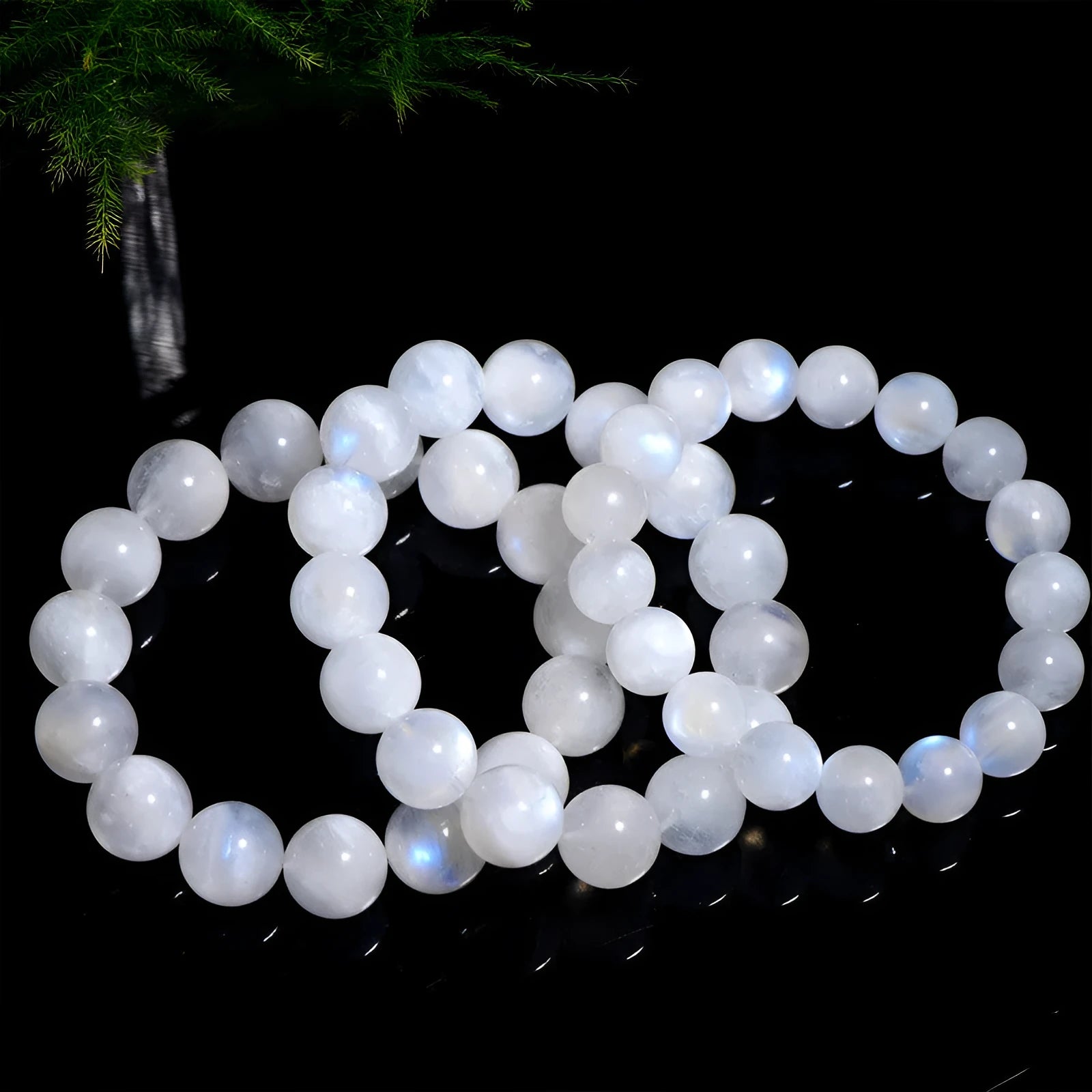 Natural blue moonlight round bead moonstone bracelet in white, showing polished stone surface.