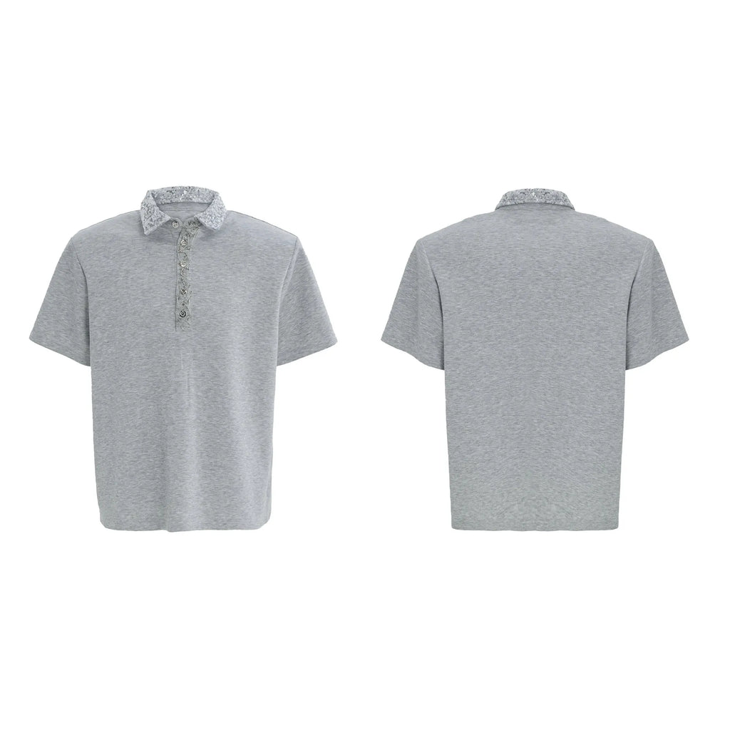 Men's black loose-fit short-sleeve polo shirt with heavy embroidery and sequin detailing on the square collar.
