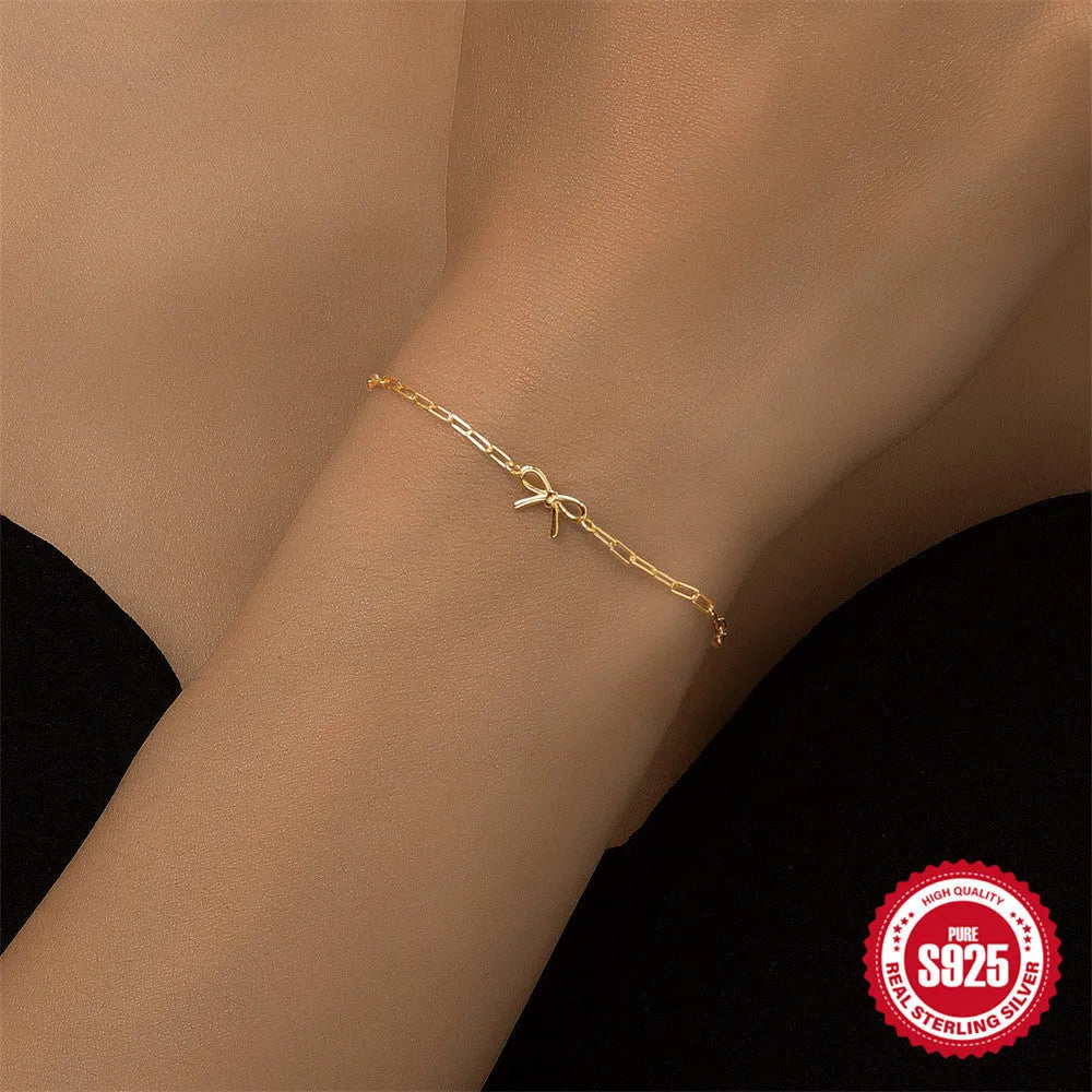 Gold-colour sterling silver bracelet with heart charm and clip chain fastening