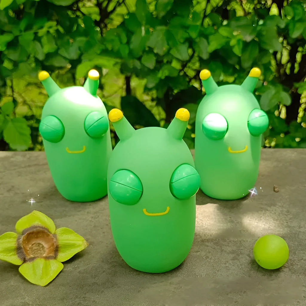 Green caterpillar squeaky toy with eye-popping feature, 8cm long PVC decomposition prank item