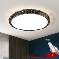 Round black iron frame LED ceiling light with dimming control on a white ceiling