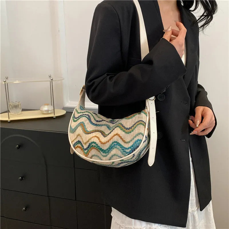 Women's woven straw crossbody bag showing textured surface and internal phone pocket